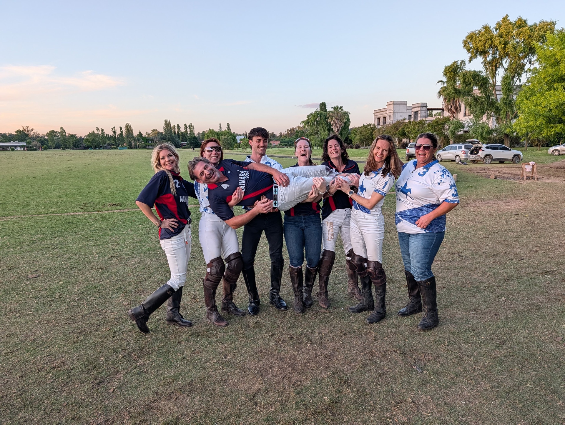 Last year's trip group celebrating together on an Argentine polo field at sunset