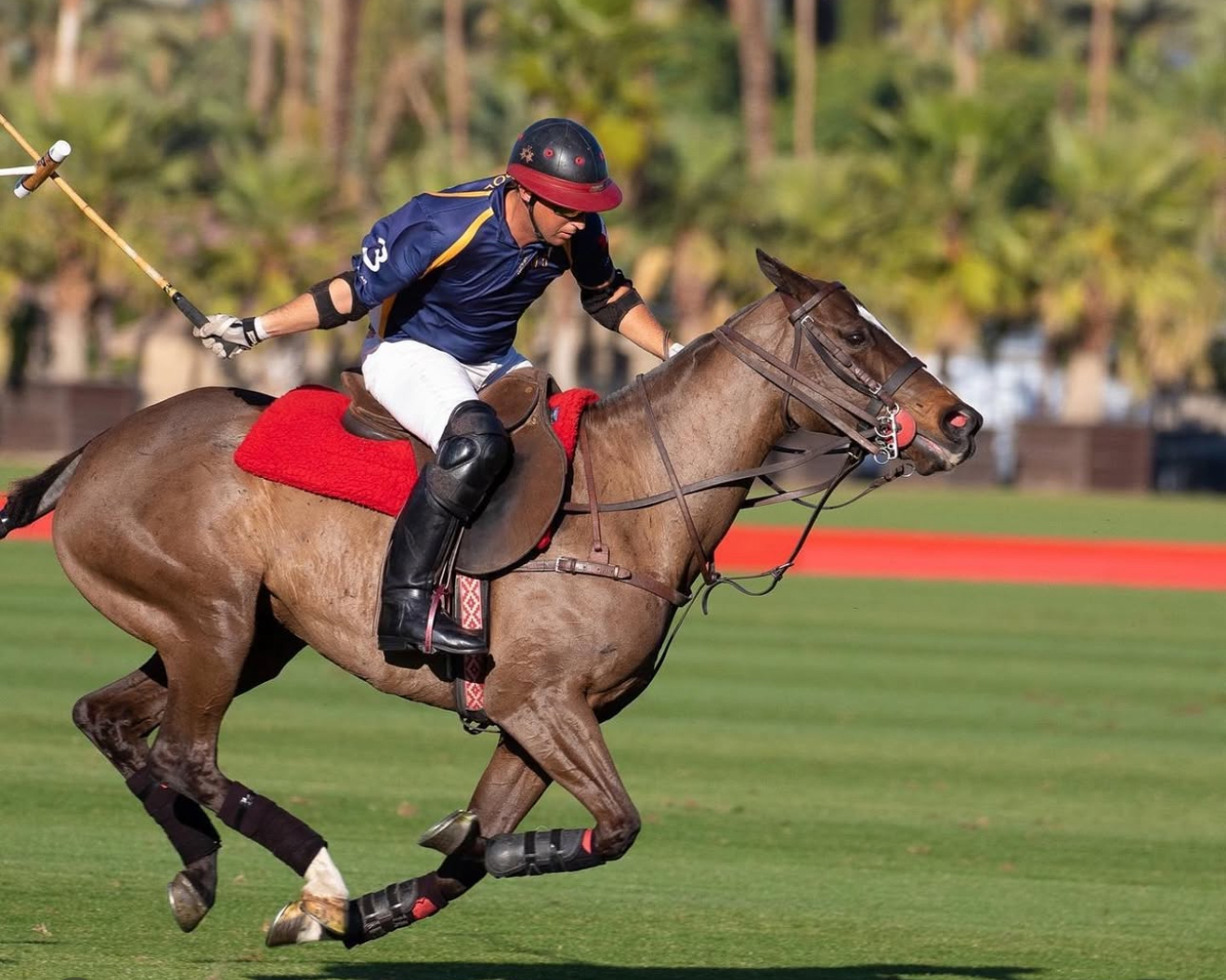 Jared Sheldon riding at speed during a polo match